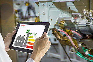 Energy efficiency scale visible on tablet in industrial environment